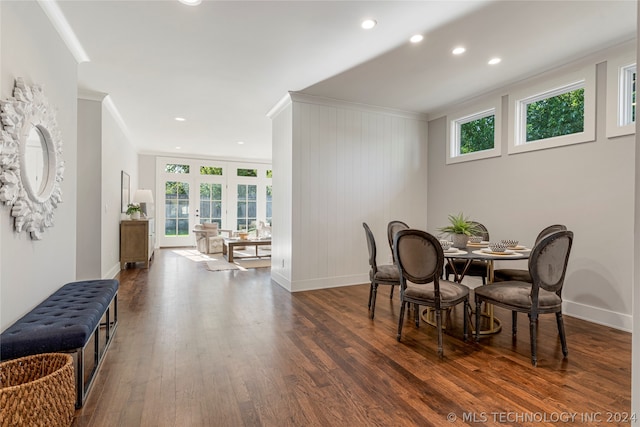 dining area featuring dark wood-type flooring and ornamental molding