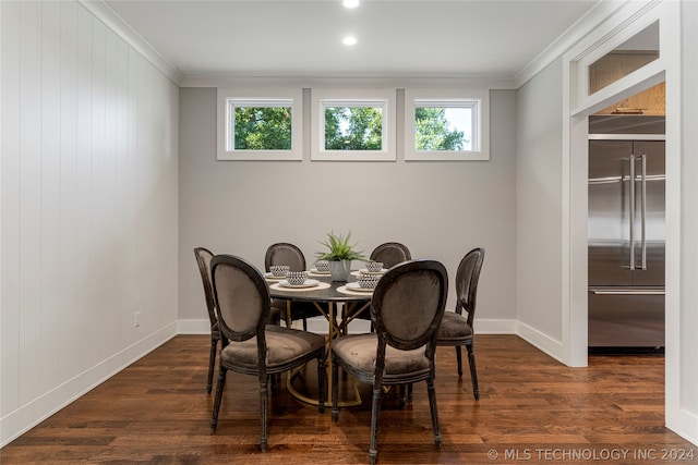 dining space featuring crown molding, dark hardwood / wood-style flooring, and plenty of natural light