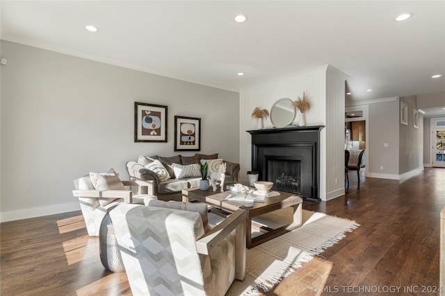 living room featuring dark hardwood / wood-style flooring and ornamental molding