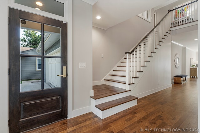 entryway with crown molding and dark hardwood / wood-style floors