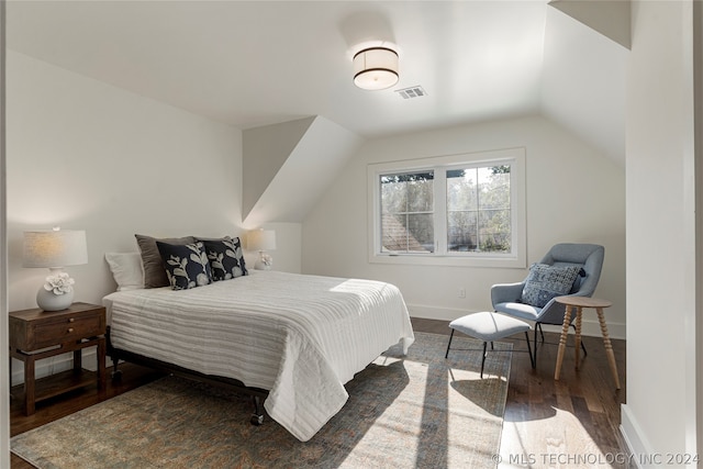 bedroom featuring vaulted ceiling and dark hardwood / wood-style flooring