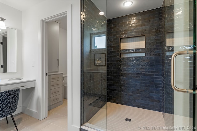 bathroom featuring vanity, walk in shower, and tile patterned floors