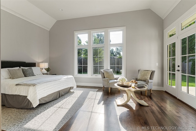 bedroom with vaulted ceiling, access to exterior, multiple windows, and hardwood / wood-style floors