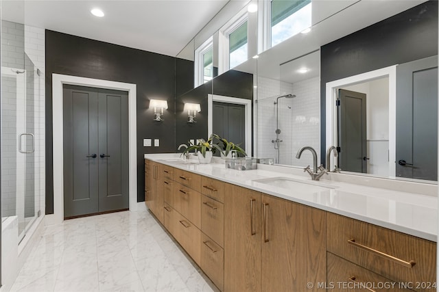 bathroom with tile patterned flooring, dual vanity, and an enclosed shower