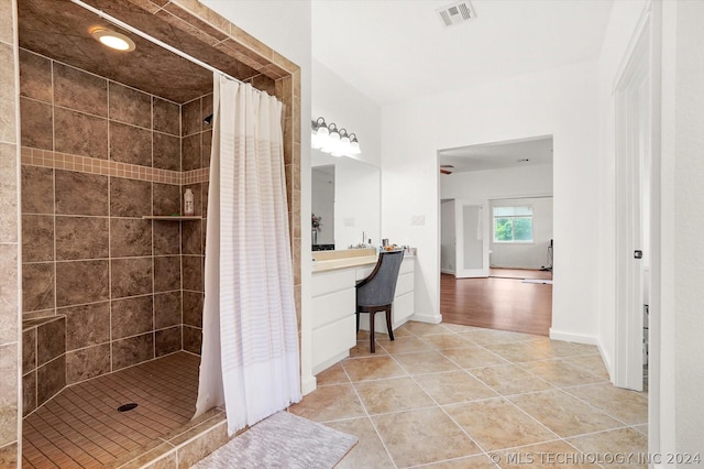 bathroom with tile patterned flooring, vanity, and curtained shower