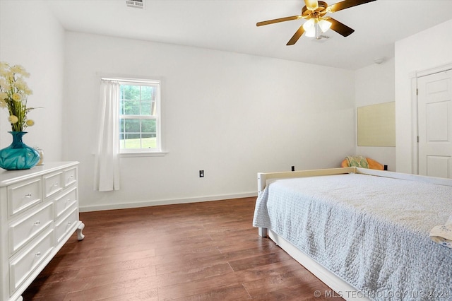 bedroom with ceiling fan and dark wood-type flooring