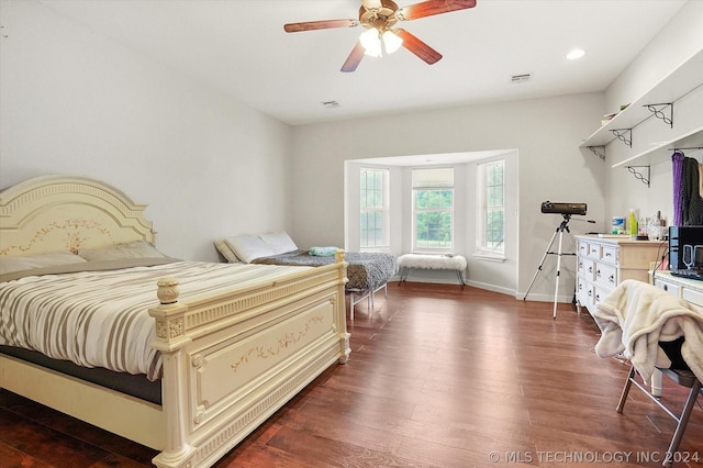 bedroom with ceiling fan and dark hardwood / wood-style floors