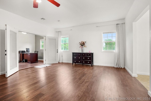 interior space with dark wood-type flooring and ceiling fan