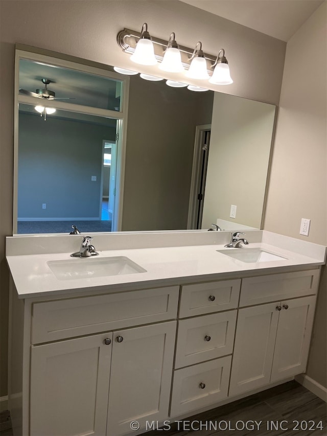 bathroom featuring ceiling fan and dual bowl vanity