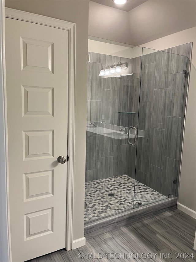 bathroom with a shower with shower door