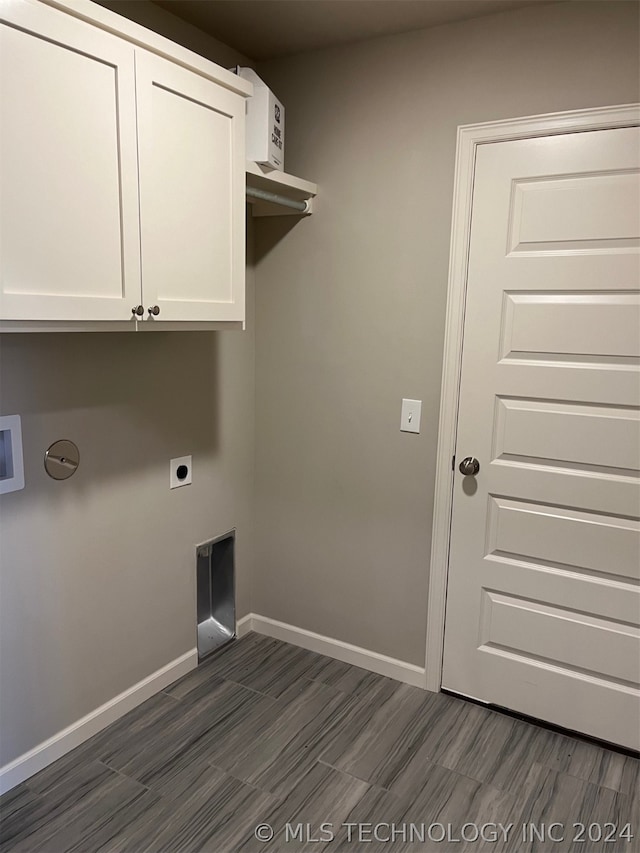 laundry area featuring electric dryer hookup and cabinets