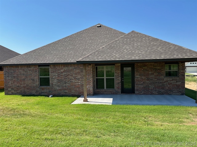 back of property featuring a patio and a yard