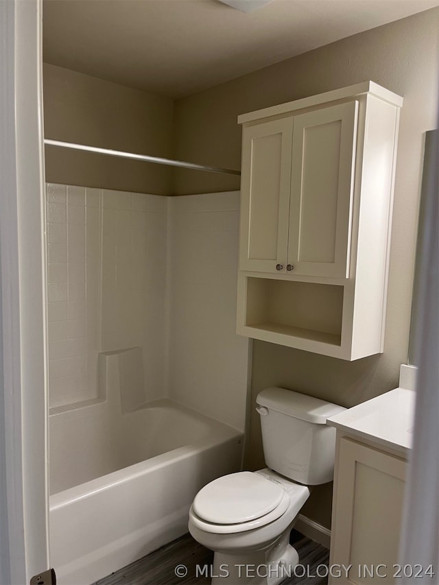 full bathroom featuring vanity, toilet, washtub / shower combination, and hardwood / wood-style floors