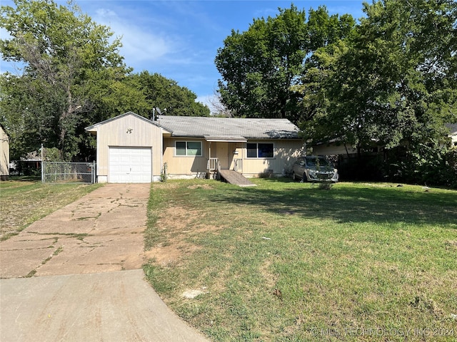 ranch-style house with a garage and a front lawn