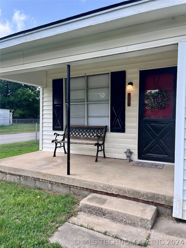 view of exterior entry with covered porch