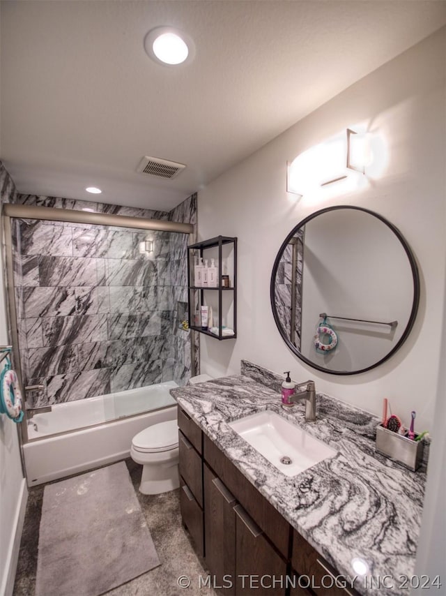 bathroom with toilet, shower / bath combination with glass door, visible vents, and vanity