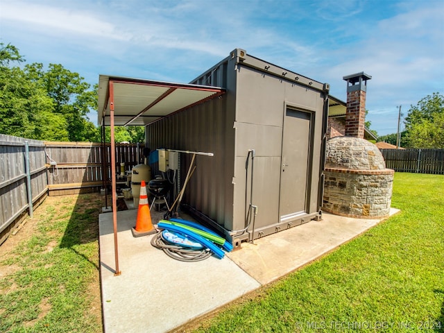 view of outdoor structure with a fenced backyard and an outdoor structure