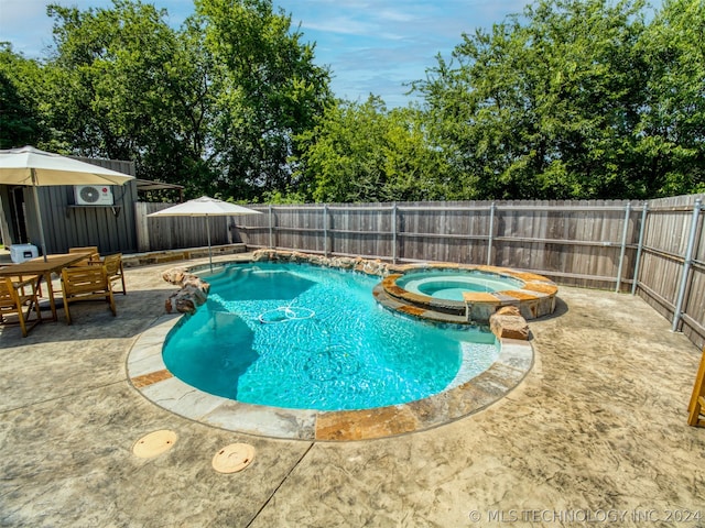 view of swimming pool with a patio, a fenced backyard, and a pool with connected hot tub