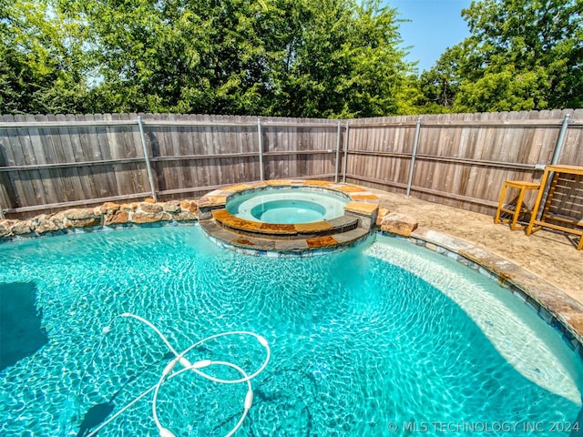 view of pool with a fenced in pool, a fenced backyard, and an in ground hot tub