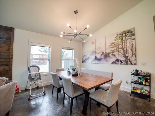 dining area featuring finished concrete flooring, an inviting chandelier, baseboards, and vaulted ceiling