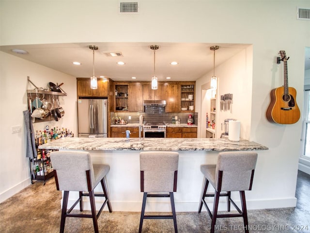 kitchen with a breakfast bar, pendant lighting, open shelves, visible vents, and appliances with stainless steel finishes