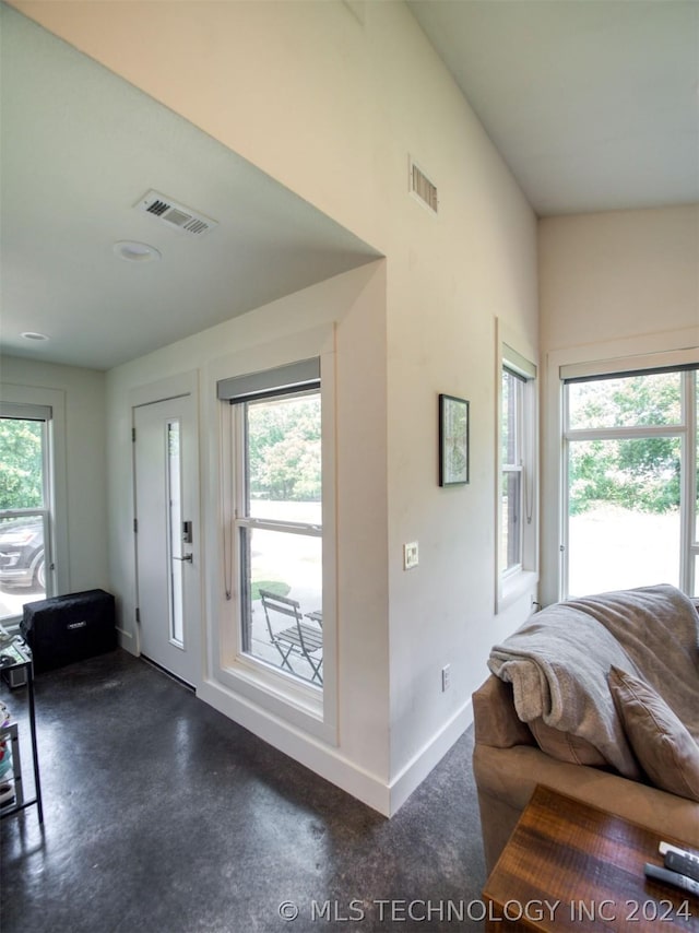 foyer entrance with visible vents and a healthy amount of sunlight