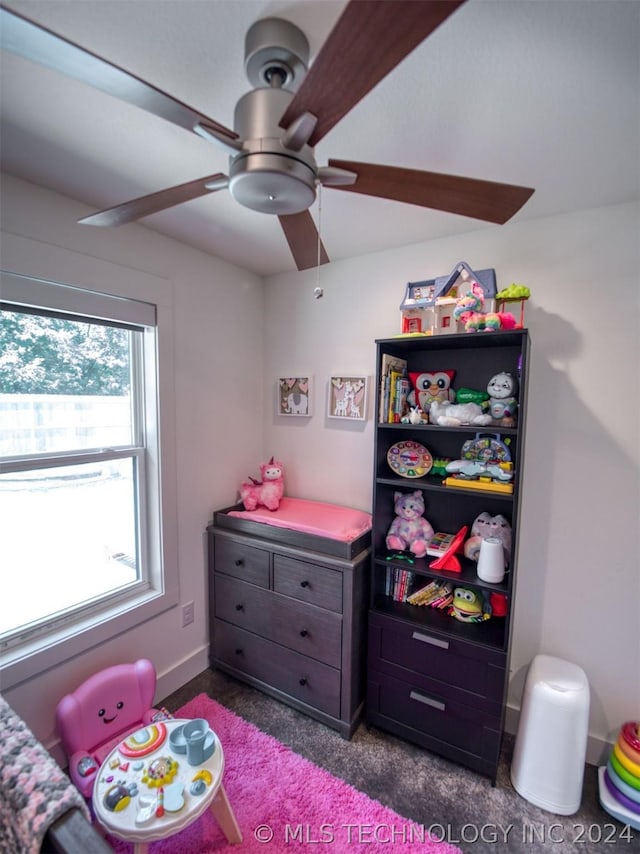 bedroom with a ceiling fan, dark carpet, and baseboards