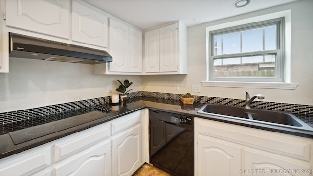 kitchen featuring black appliances, dark countertops, under cabinet range hood, and a sink