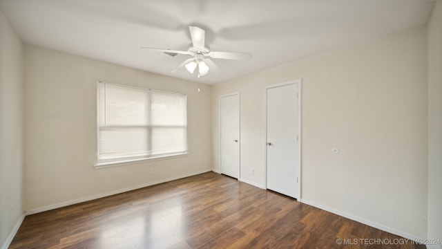 unfurnished bedroom with baseboards, wood finished floors, and a ceiling fan