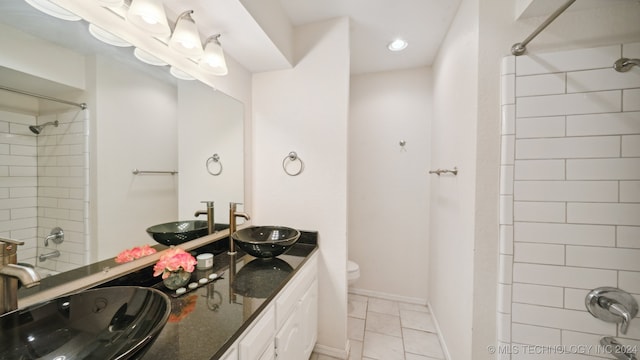 full bathroom featuring tile patterned floors, toilet, and a sink