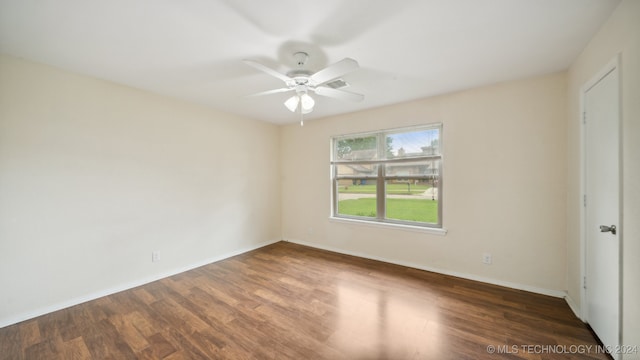 unfurnished room featuring wood finished floors, baseboards, and ceiling fan