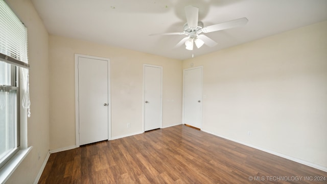 unfurnished bedroom with ceiling fan, baseboards, and wood finished floors