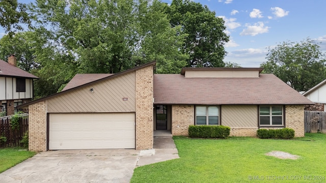 view of front of home featuring a garage and a front yard