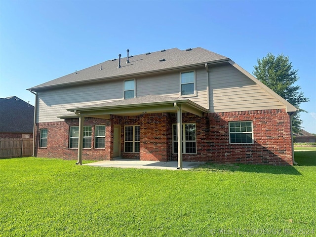 rear view of property featuring a patio area and a lawn