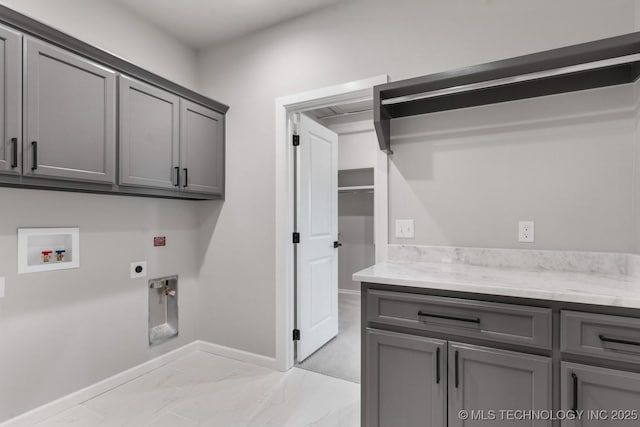 laundry room with washer hookup, marble finish floor, cabinet space, hookup for an electric dryer, and baseboards