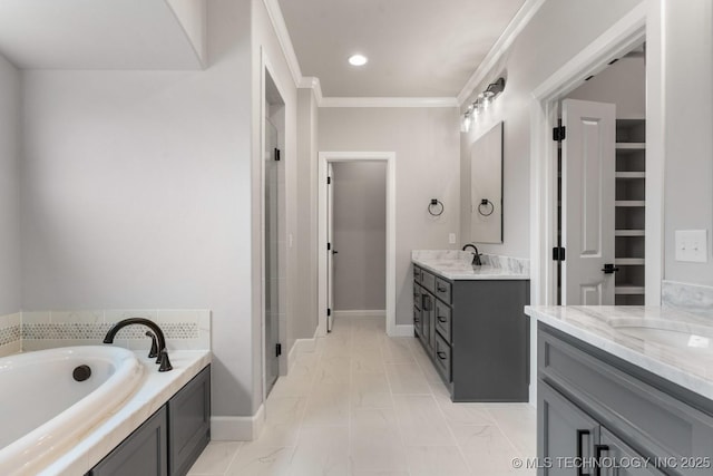 full bathroom with a garden tub, two vanities, a sink, ornamental molding, and a shower stall