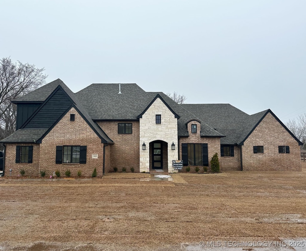 french country home featuring a front lawn