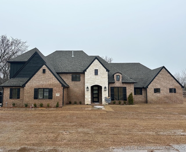 french country home featuring a front lawn