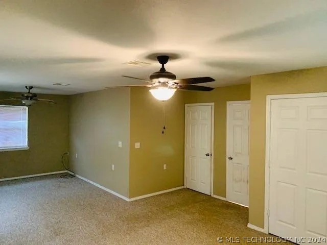 unfurnished bedroom featuring carpet floors and ceiling fan