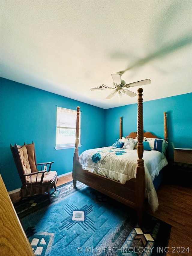 bedroom featuring dark hardwood / wood-style flooring and ceiling fan