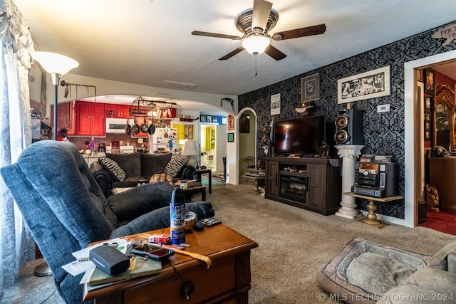 carpeted living room featuring ceiling fan