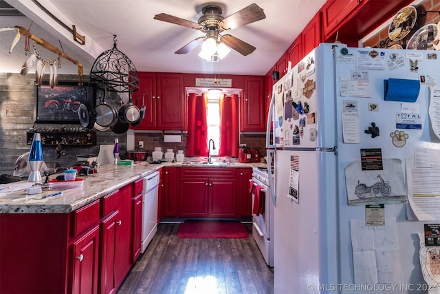 kitchen with tasteful backsplash, white appliances, dark wood-type flooring, ceiling fan, and sink