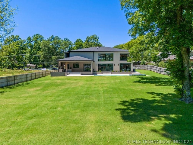 rear view of house with a yard