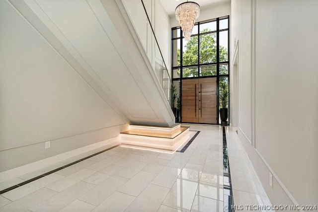 entryway featuring light tile patterned flooring and an inviting chandelier