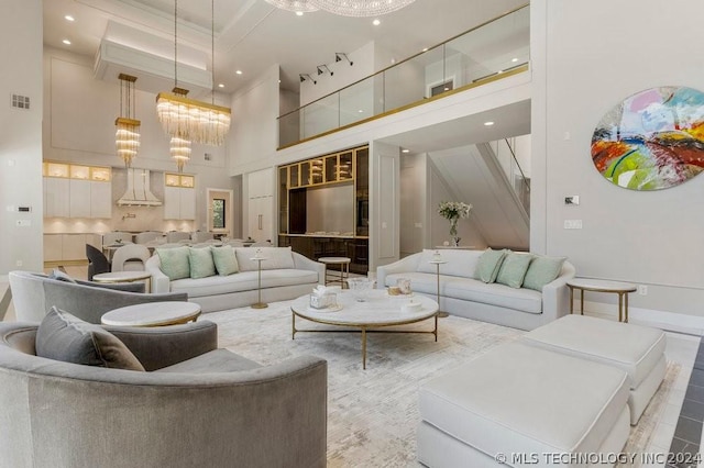 living room with a high ceiling and a notable chandelier