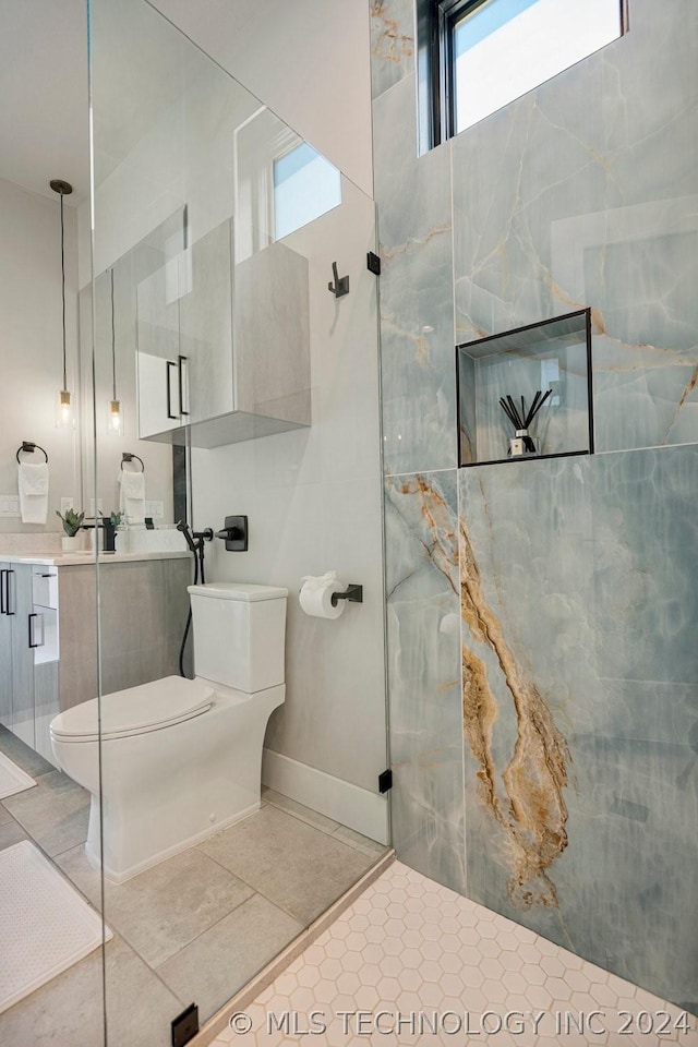 bathroom with toilet, tile patterned flooring, walk in shower, and vanity