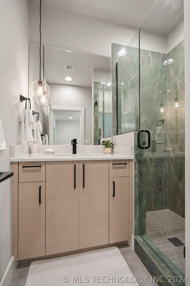 bathroom featuring walk in shower and vanity