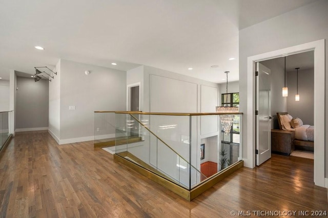 corridor with hardwood / wood-style floors