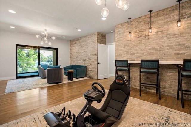 interior space featuring brick wall and wood-type flooring