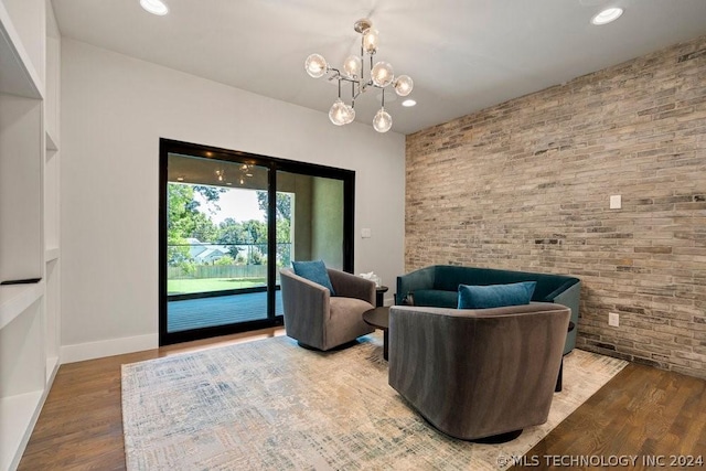 sitting room featuring wood-type flooring and a chandelier